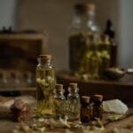 A collection of rustic glass bottles with aromatic herbs on a wooden table, perfect for aromatherapy themes. shaman